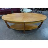 A teak oval coffee table