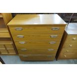 A simulated teak chest of drawers