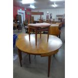 A Danish Frem Rojle teak extending dining table and two chairs