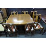 An oak draw-leaf dining table and six chairs