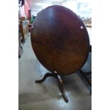 A George III oak circular tilt top tripod tea table