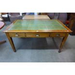 An early 20th Century oak three drawer library table