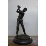 A bronze figure of a golfer, on black marble plinth (missing club)