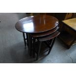 An Edward VII mahogany oval nest of tables