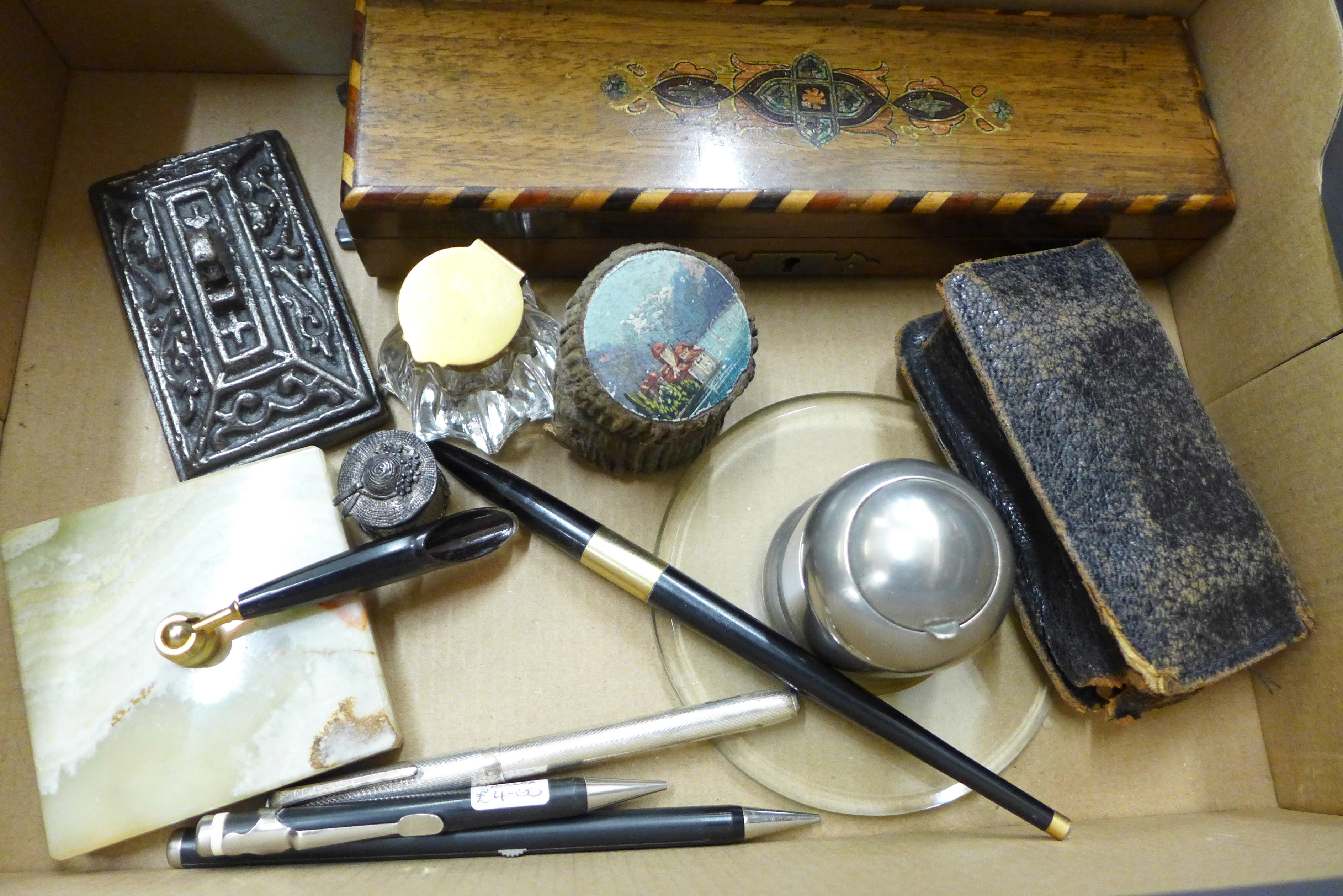 A travelling inkwell and two other inkwells, a pair of opera glasses, an inlaid pen box and a desk