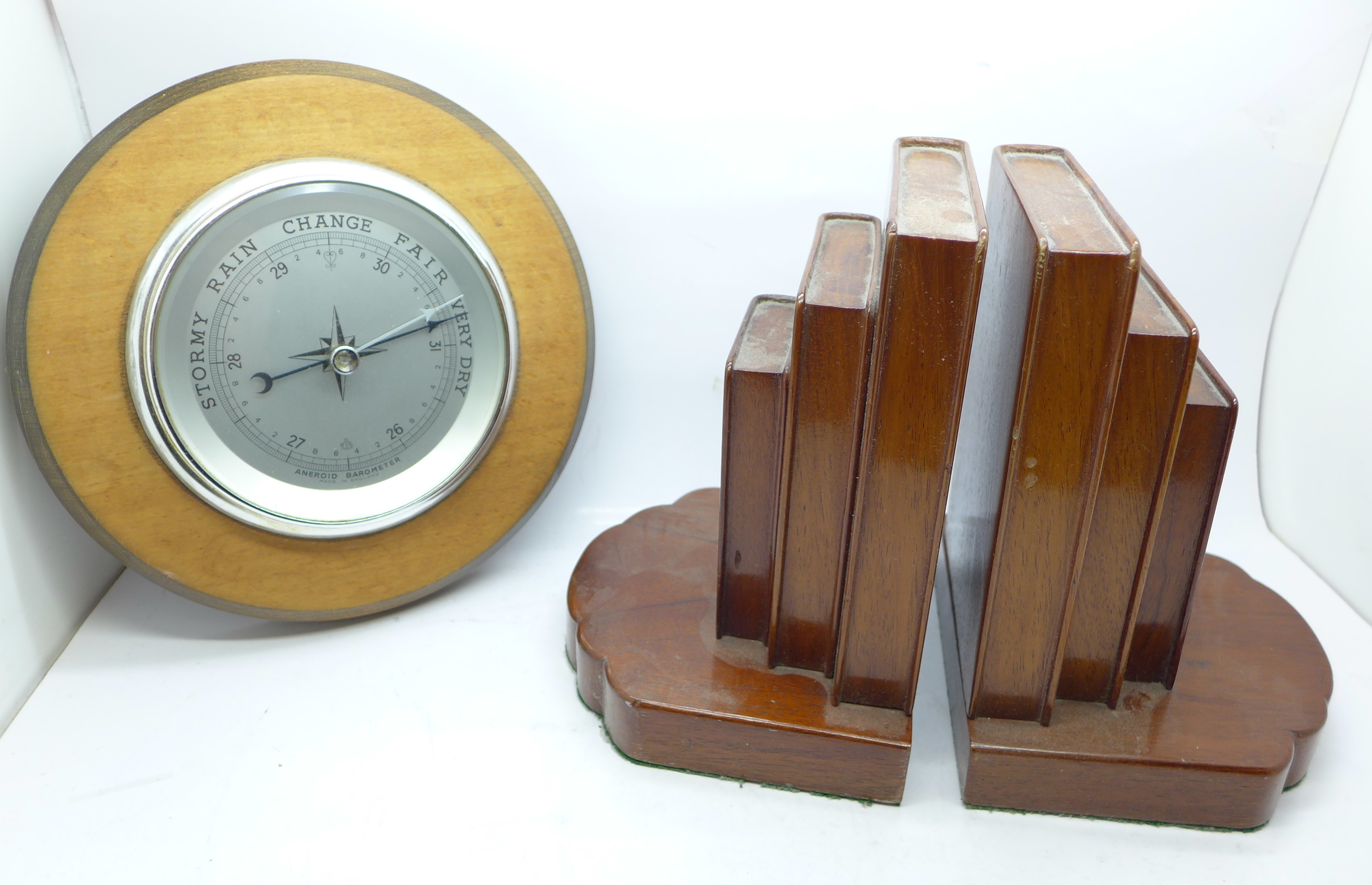 A pair of bookends and an aneroid barometer