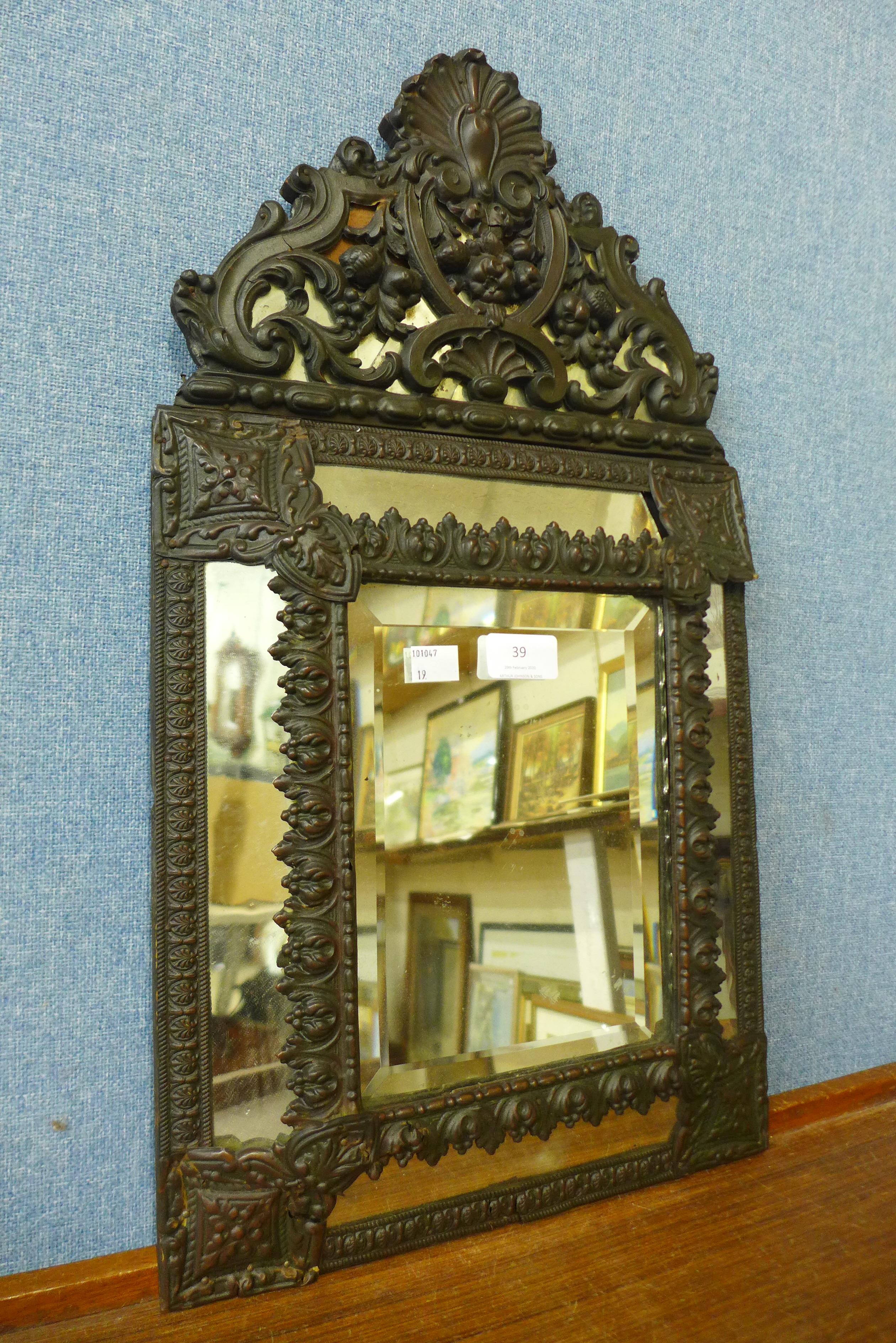 A small Baroque style metal framed mirror