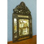 A small Baroque style metal framed mirror