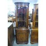 A walnut freestanding corner cabinet