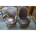 A pair of French oak and upholstered open library armchairs