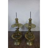 A pair of Indonesian brass candlesticks another smaller pair