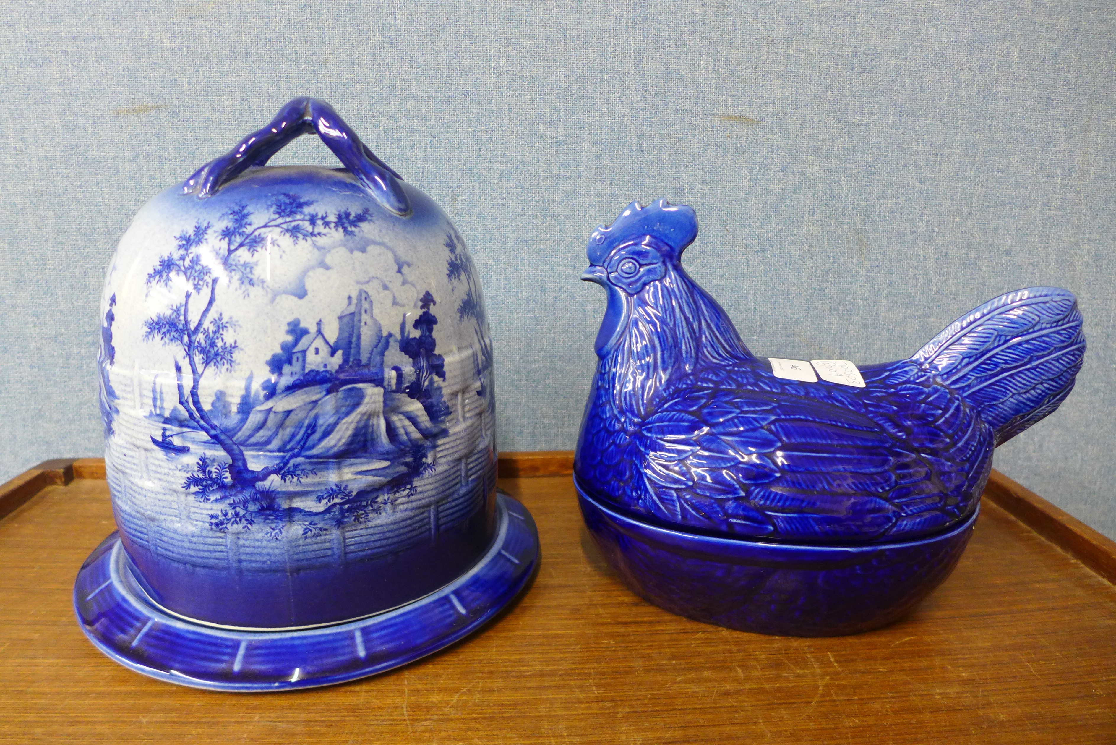 An Empress of Staffordshire flow blue cheese dome and stand, with transfer printed scene and a hen