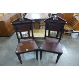 A pair of Victorian mahogany hall chairs