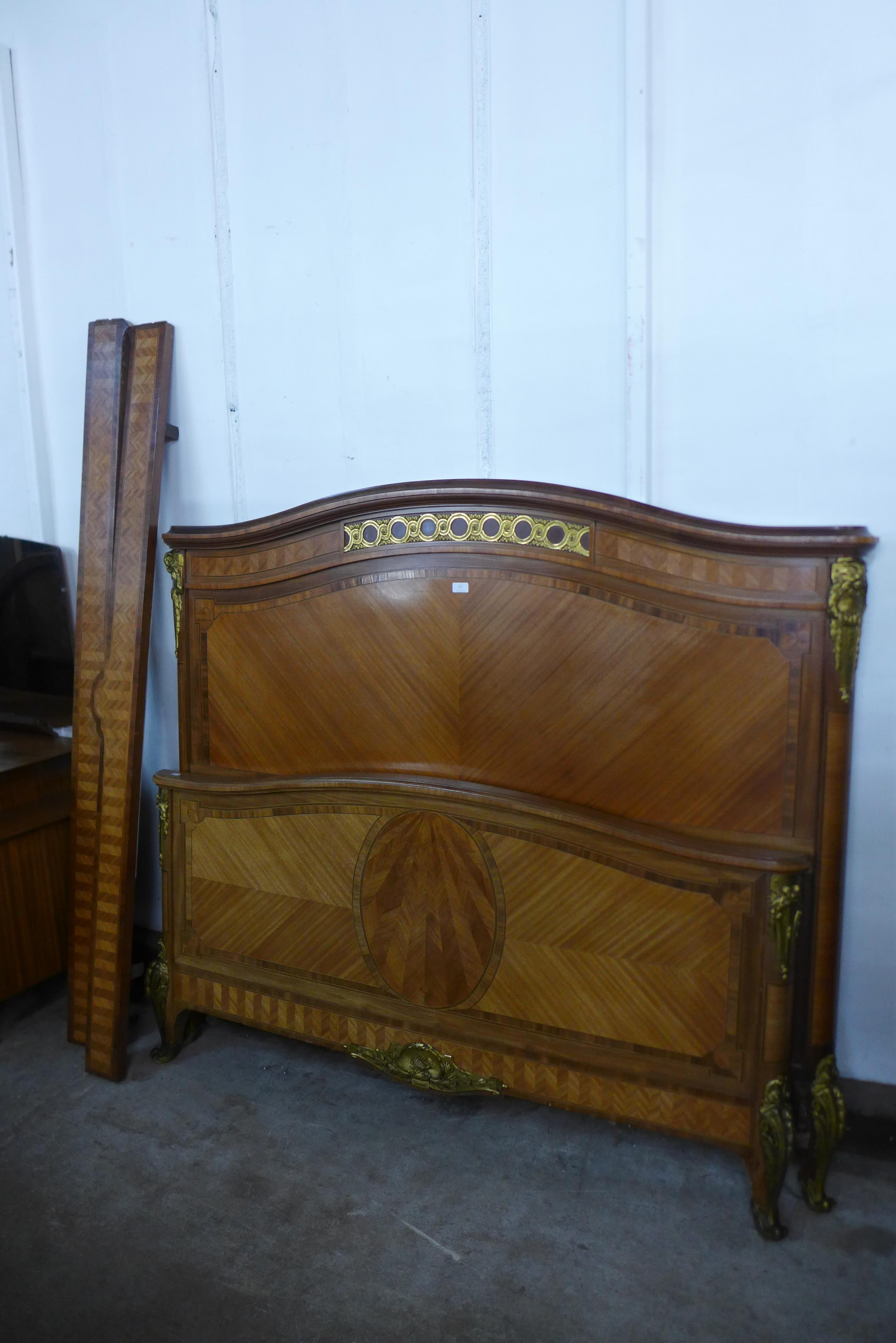 A 19th Century French Empire style inlaid mahogany and gilt metal mounted double bed