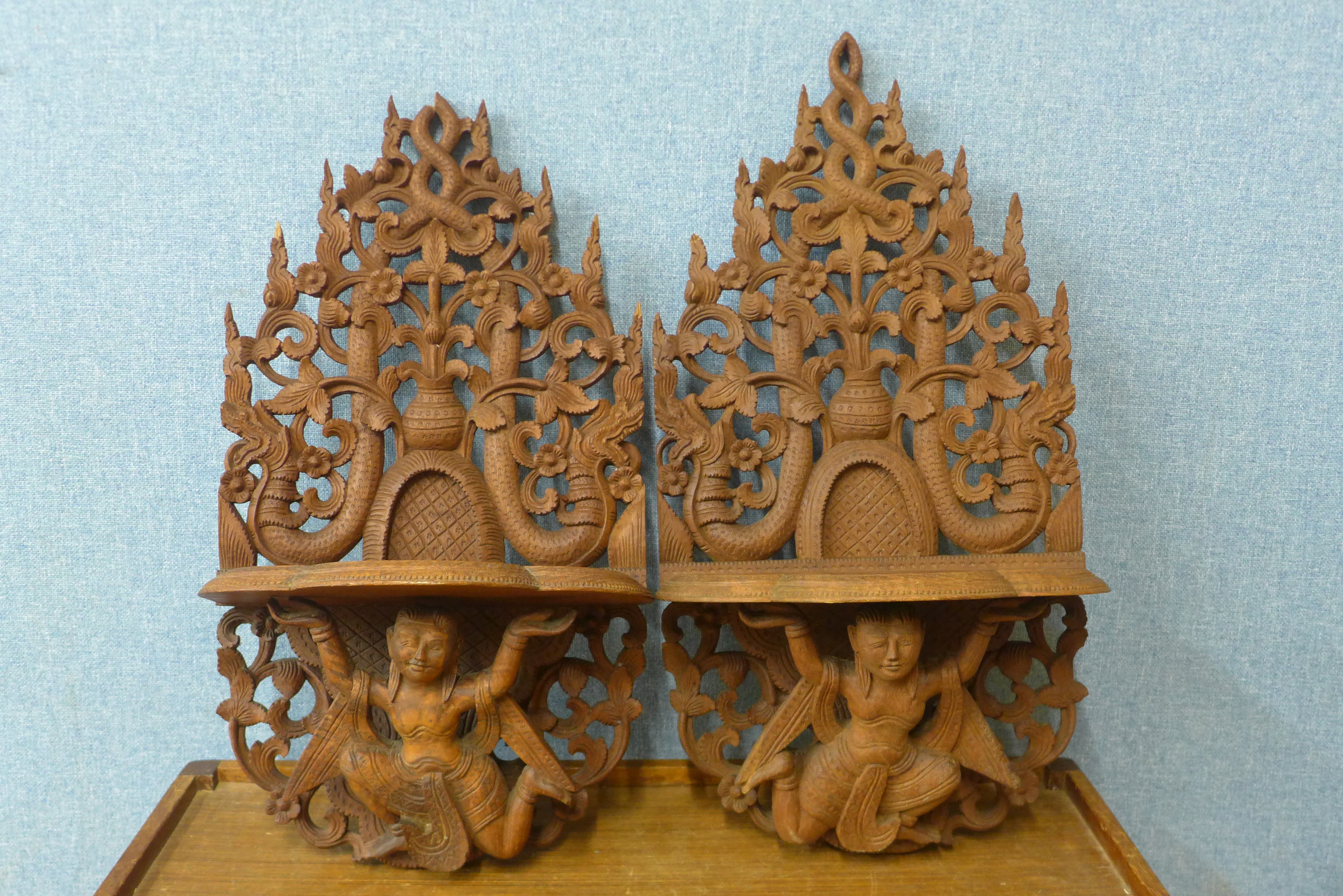 A pair of Thai carved wood wall brackets