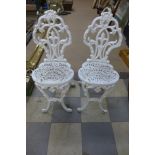 A pair of Victorian cast iron garden chairs