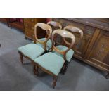 A set of four Victorian mahogany balloon back dining chairs