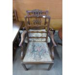 Two George III style mahogany elbow chairs