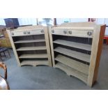 A pair of Arts and Crafts light oak open bookcases