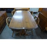 An Ercol Golden Dawn refectory table and four chairs