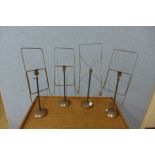A set of four copper haberdashery shop stands
