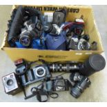 A collection of cameras and lenses, Pentax P30T with 1:3.5-4.5 28-80mm lens, flash, a Nikon D40,