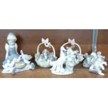 Six Lladro figures including dogs and cats in baskets, dog figure a/f