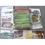 A box of approximately 600 vintage postcards, sorted into categories