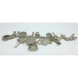 A white metal charm bracelet, 82g