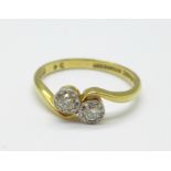 An 18ct gold, platinum set two stone diamond ring, 2.7g, O