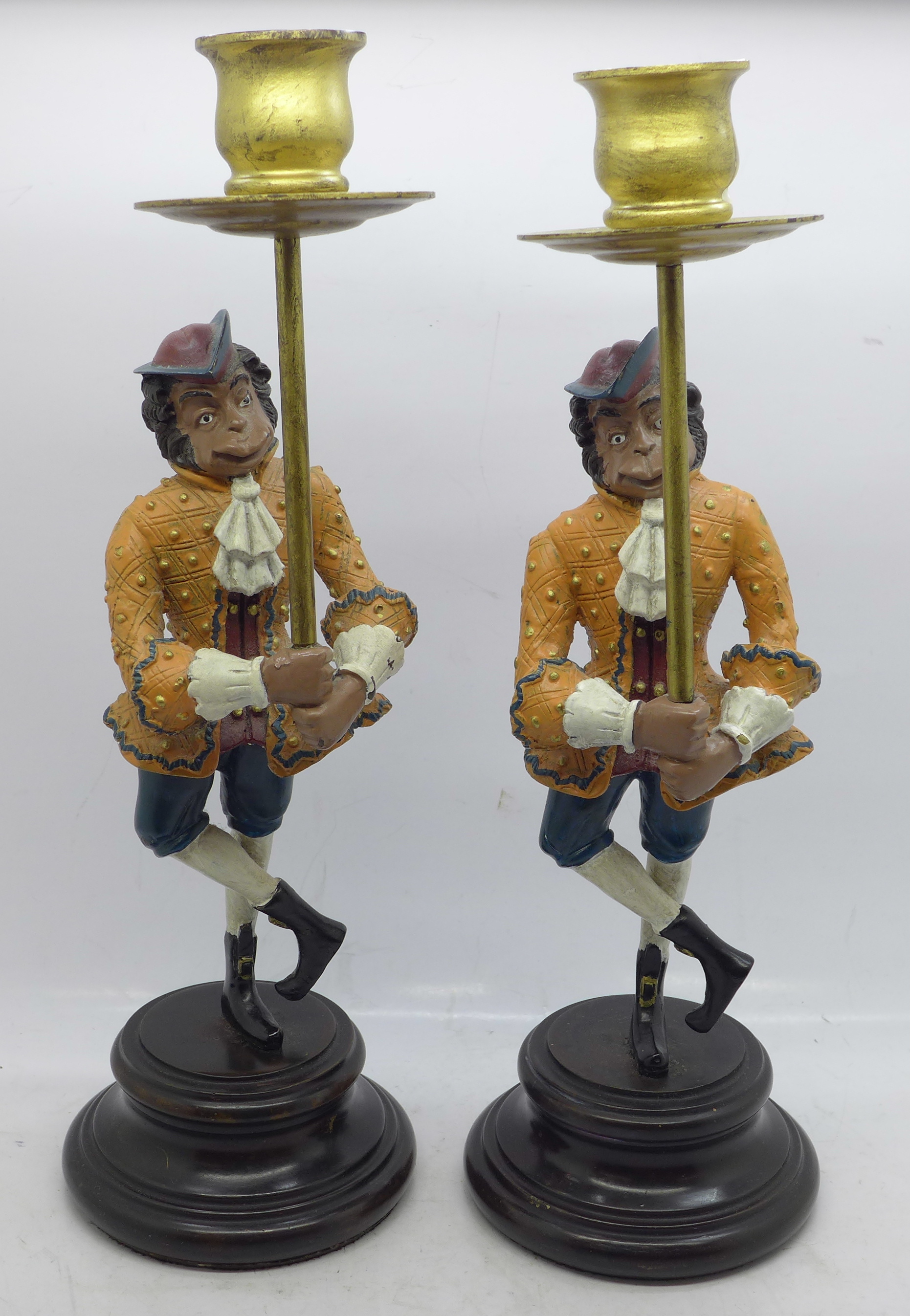 A pair of whimsical painted bronze monkey figural candlesticks, 29cm