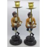 A pair of whimsical painted bronze monkey figural candlesticks, 29cm