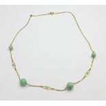 A 9ct gold and jade necklet, 3.8g