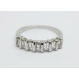 An 18ct white gold and diamond ring, (seven baguette cut diamonds), 0.5carat diamond weight, 2.8g, K