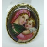 A hand painted portrait brooch