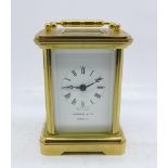 A small brass and glass carriage clock, the dial marked Garrard & Co., London, with key