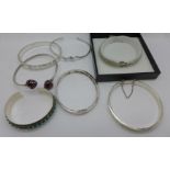 Four silver bangles and a bracelet, and two white metal bangles