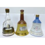 Two Wade Bell's Whisky decanters, one with contents and an empty musical decanter