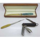 A British Army jack knife, 1947, a bronze handled paper knife and one other paper knife with