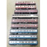 A collection of nine model railway carriages