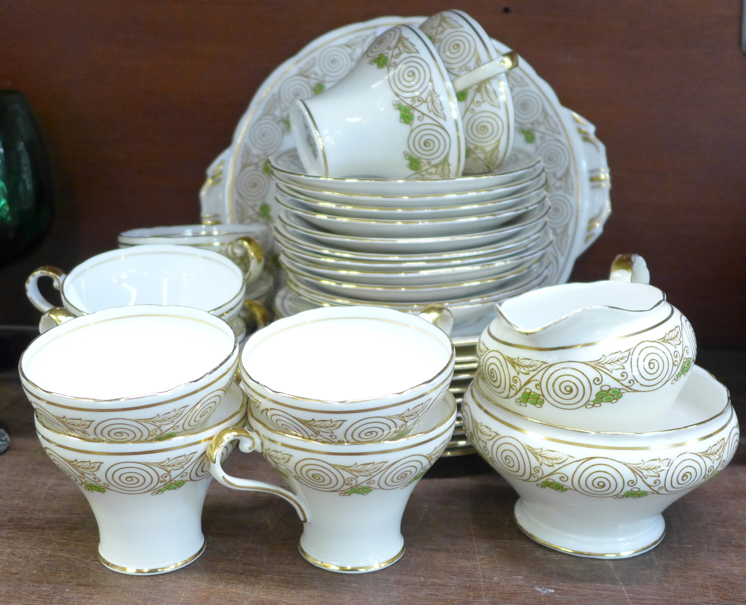 An Aynsley tea set, B4664, eleven setting, lacking one cup, with cream, sugar and sandwich plate