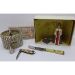 A Queen Elizabeth II Coronation figure, boxed, a British Armed Forces three pence note, knife and an