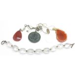 Four hardstone pendants on silver chains and a silver mounted quartz bracelet