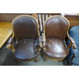 A pair of French oak and upholstered open library armchairs