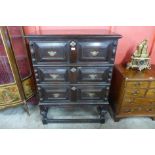 A 17th Century style oak geometric moulded chest on stand