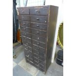 A painted pine twenty-four drawer watchmaker's chest