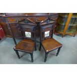 A pair of Victorian mahogany hall chairs