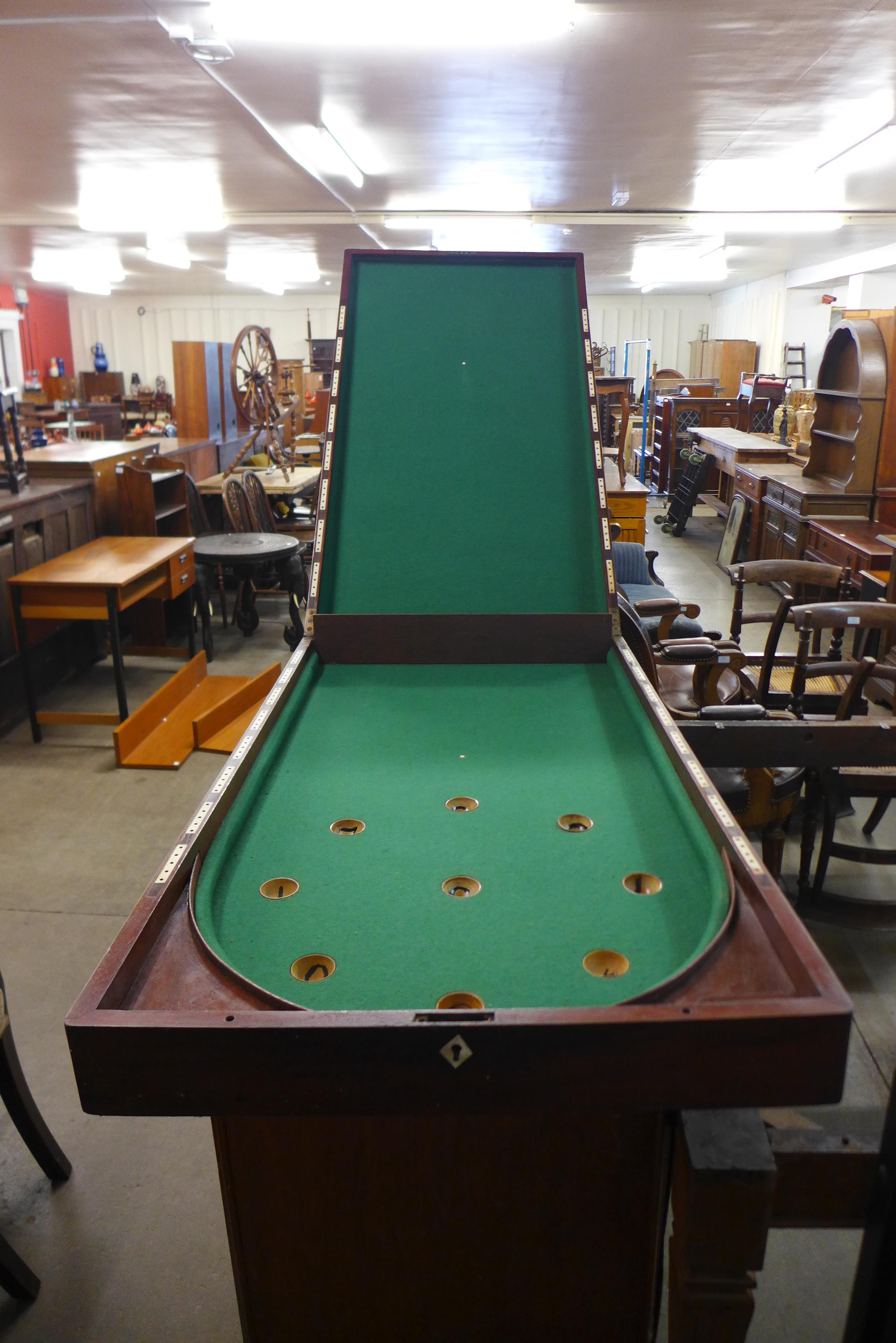 A Victorian mahogany bagatelle board and cues