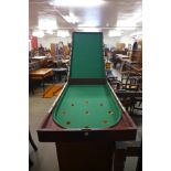 A Victorian mahogany bagatelle board and cues