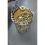 A J. Marston Thompson & Son stoneware flagon in wicker container